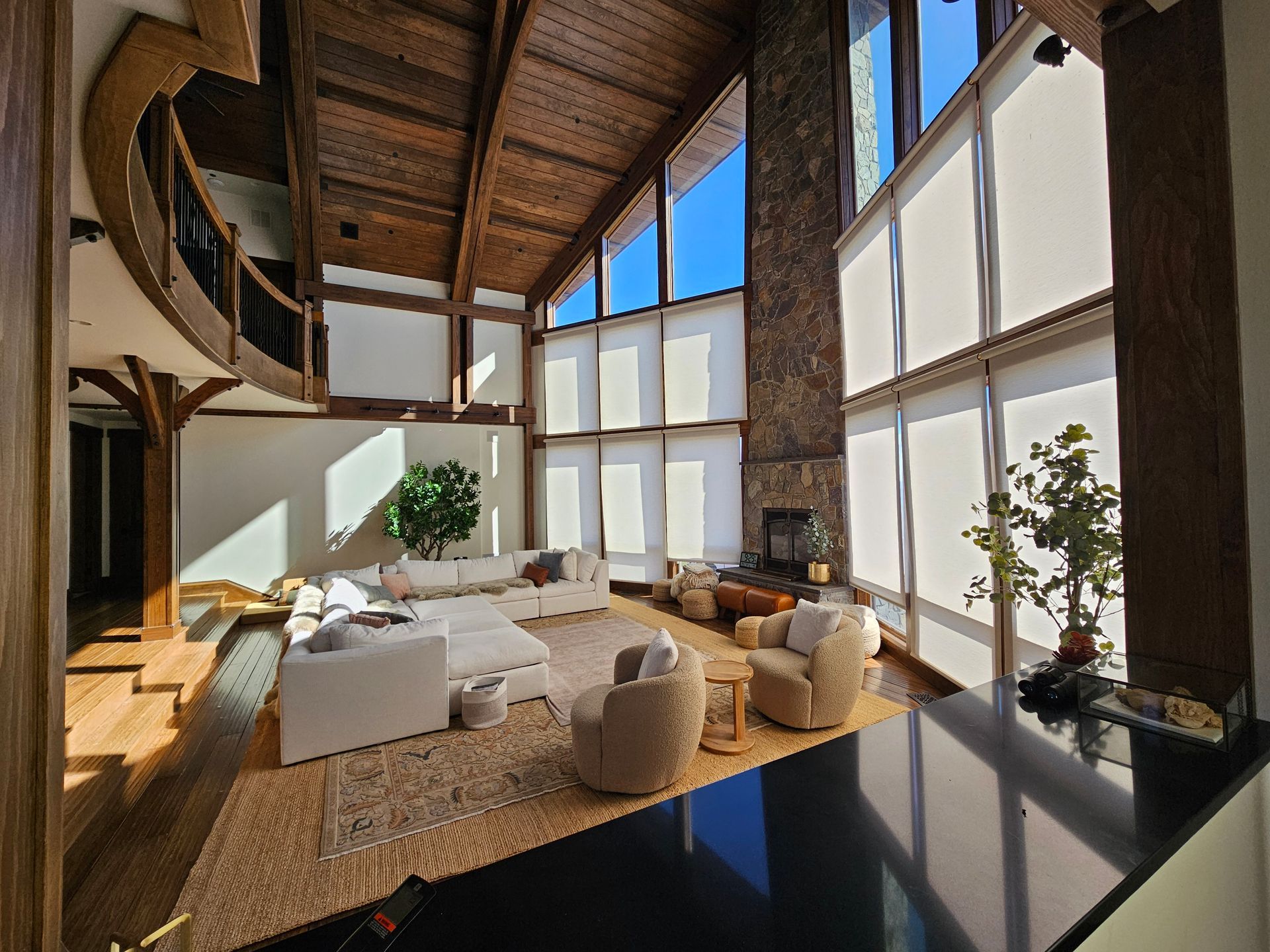 A living room with a lot of windows and furniture