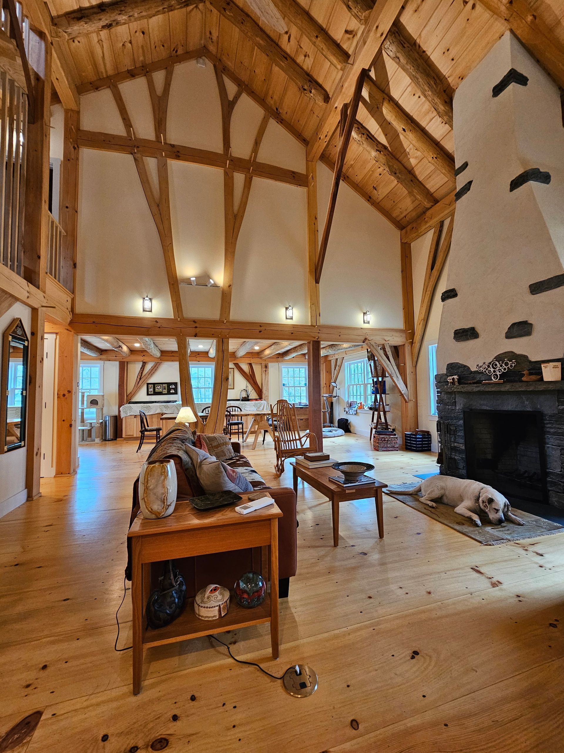 A living room with wooden beams and a fireplace