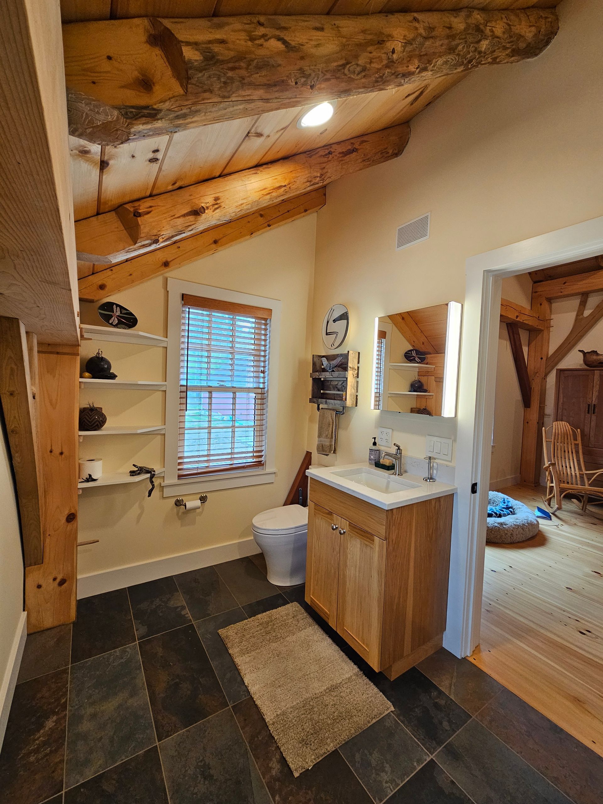 A bathroom with a toilet , sink , and mirror.