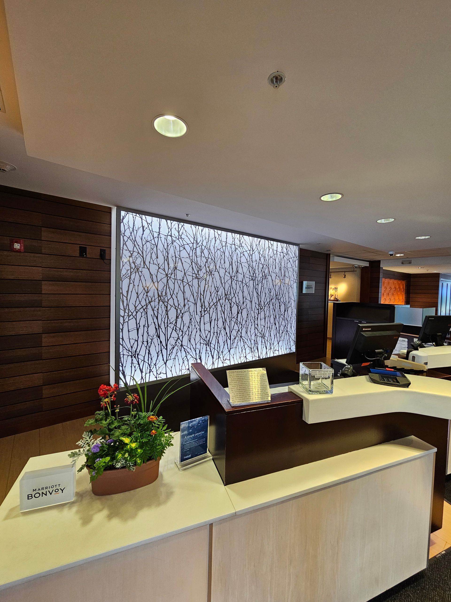 A reception desk in a hotel with flowers on it