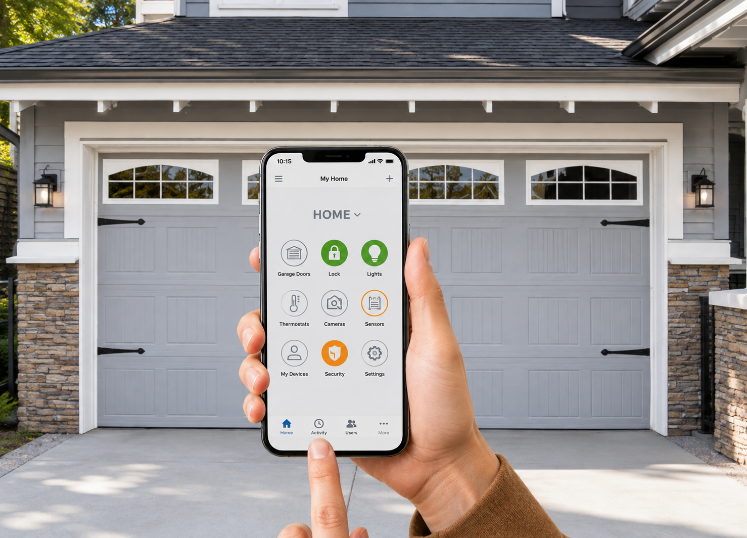 Hand holding a smartphone with smart home controls in front of a two-car garage.