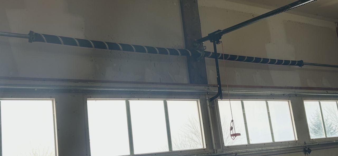 Industrial interior with high windows and exposed steel beams, lit by daylight.