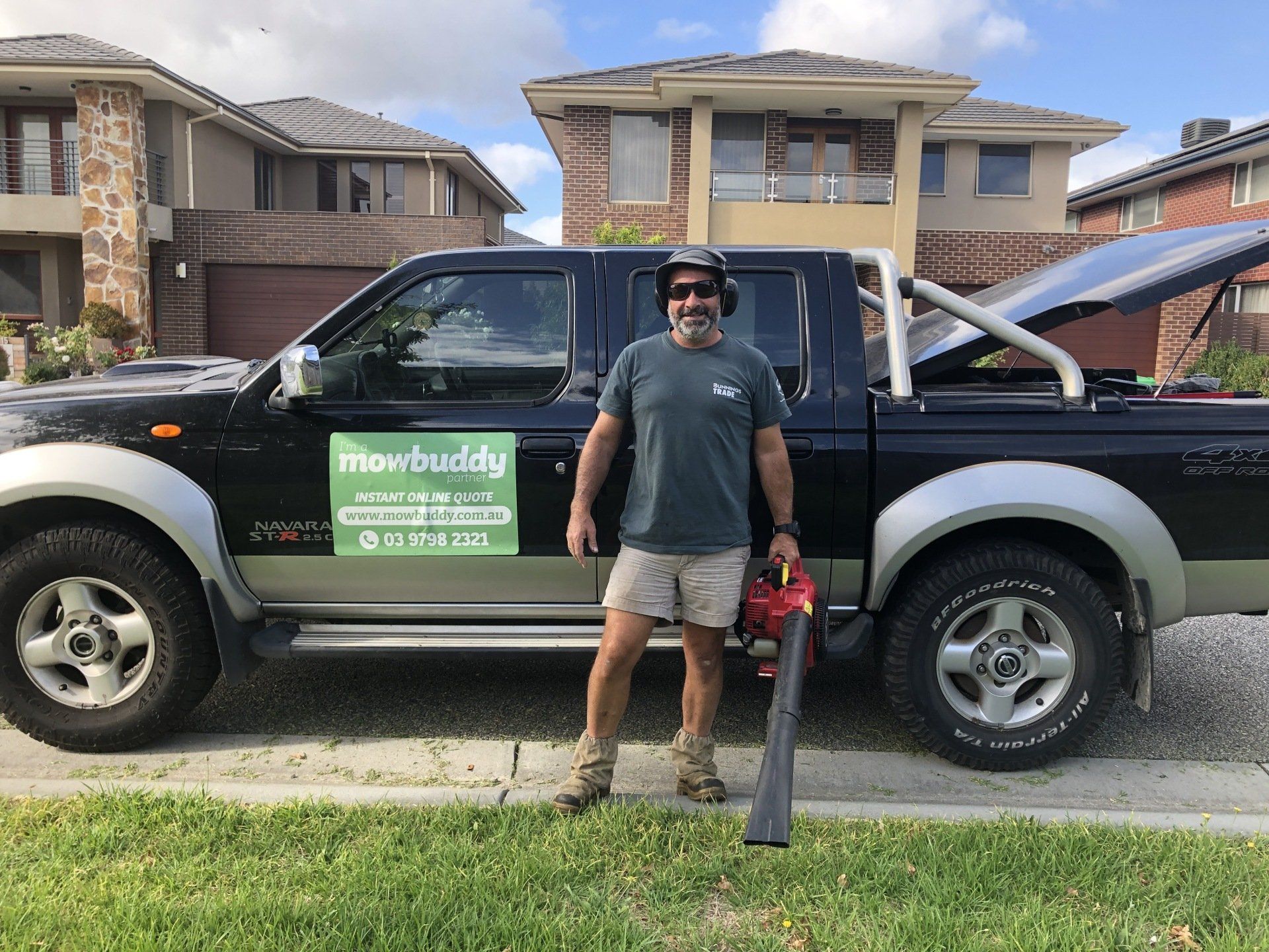 Mowbuddy Jayson standing next to his ute
