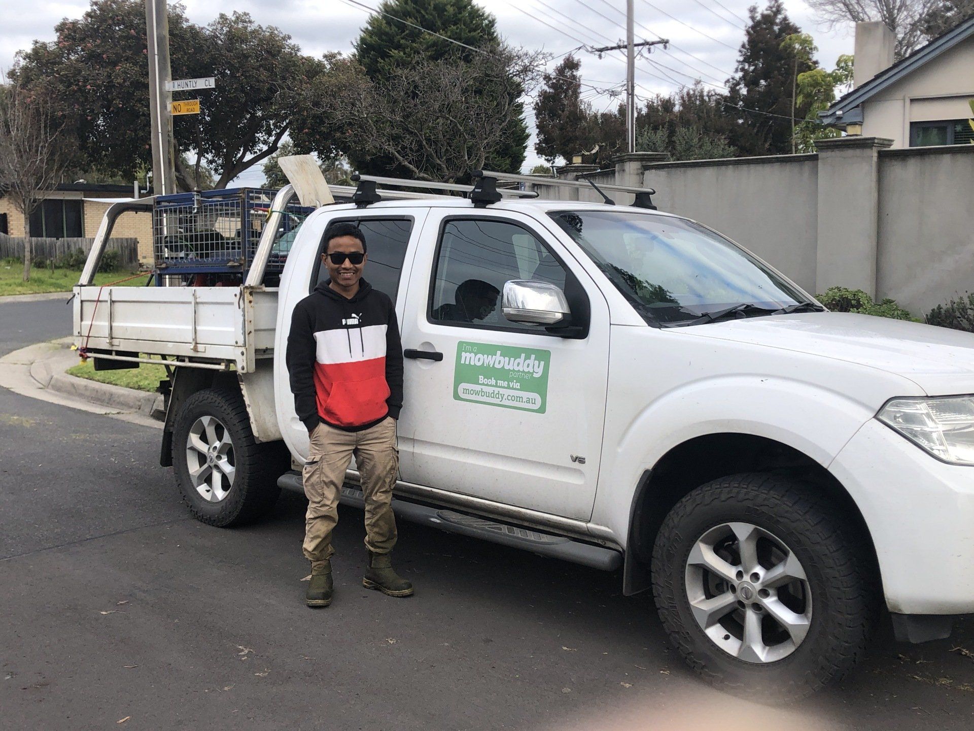 Mowbuddy gardener standing next to his ute and equipment