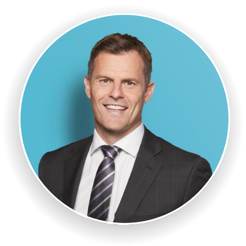 A man in a suit and tie is smiling in a circle