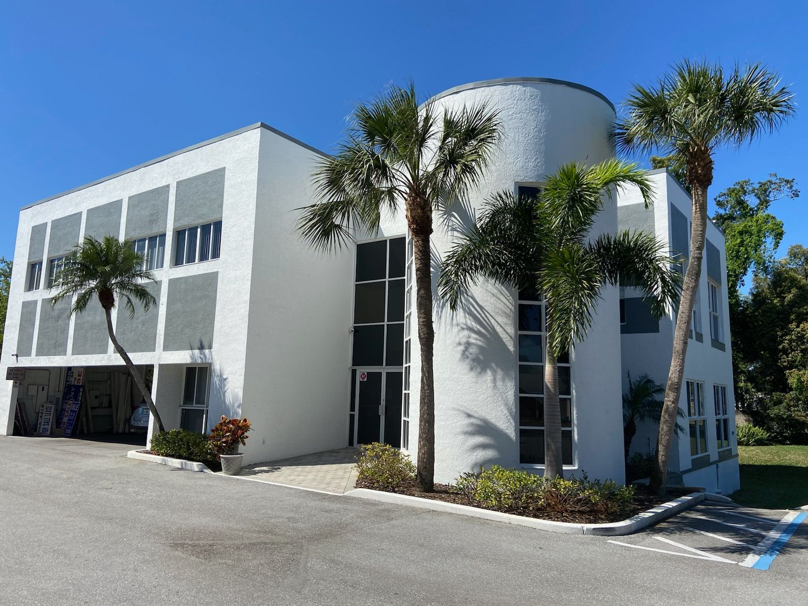 A large white building with palm trees in front of it