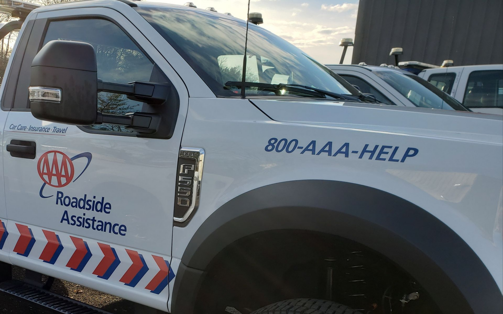 AAA roadside assistance truck with 800-AAA-HELP on the door, parked outdoors