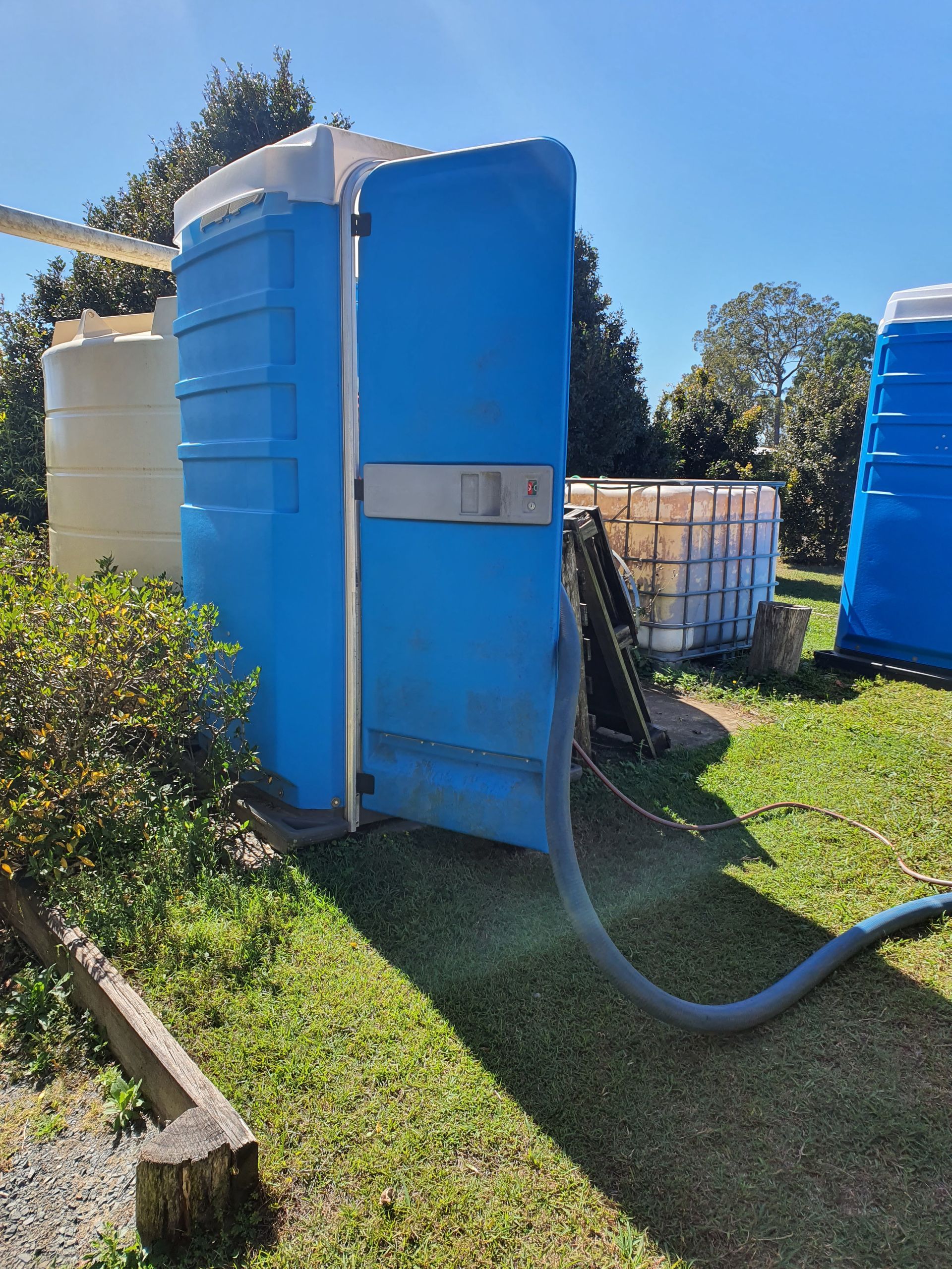 Worker Cleaning The Septic Tank With Water — Waste Disposal in Hervey Bay, QLD