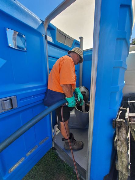 AA Waste Disposal Truck Man Pumping Out Waste From a Portaloo — Waste Disposal in Maryborough, QLD AA Waste Disposal Truck Man Pumping Out Waste From a Portaloo— Waste Disposal in Maryborough, QLD