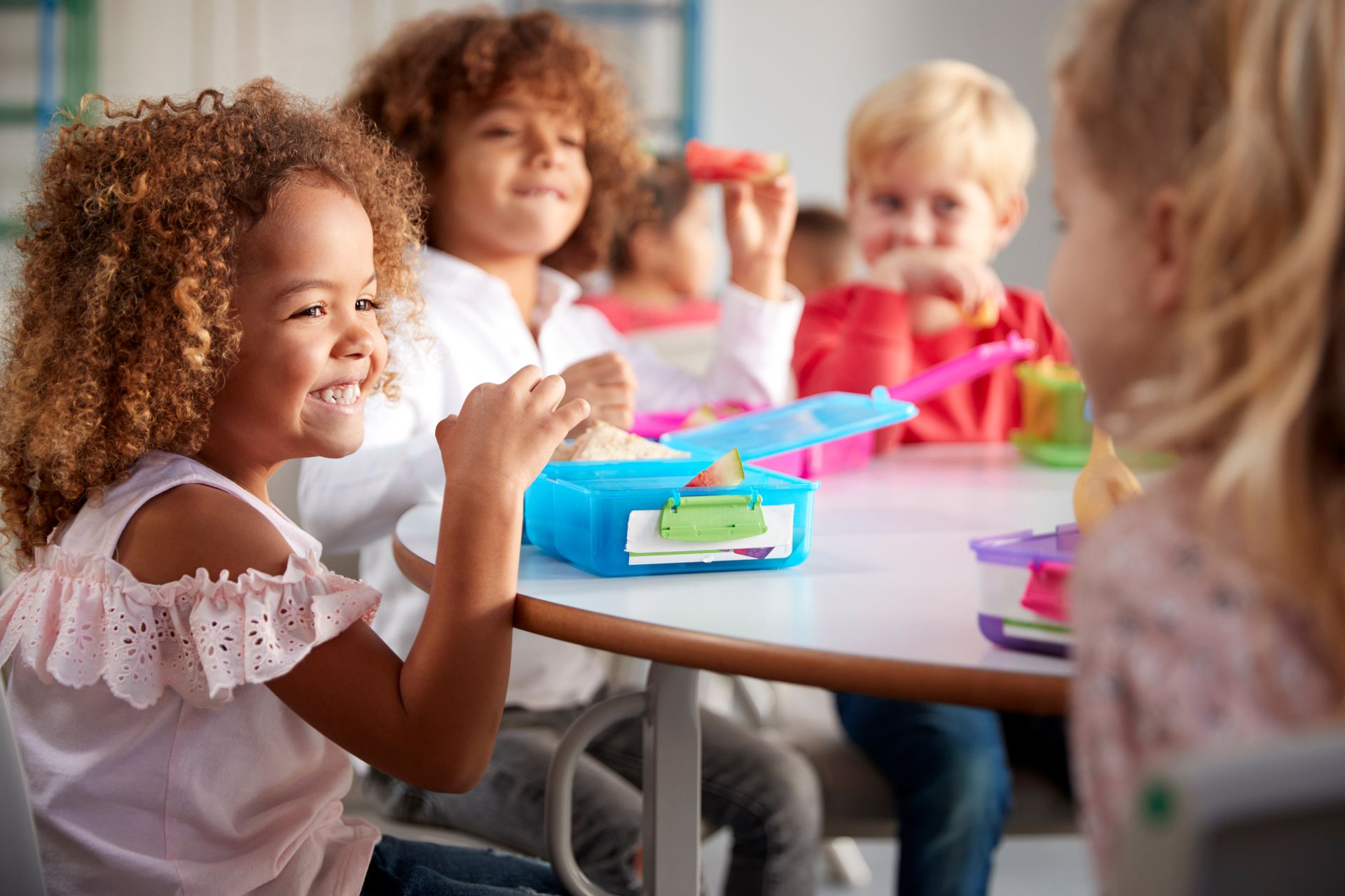 Child helping prepare a healthy lunch with colorful ingredients
