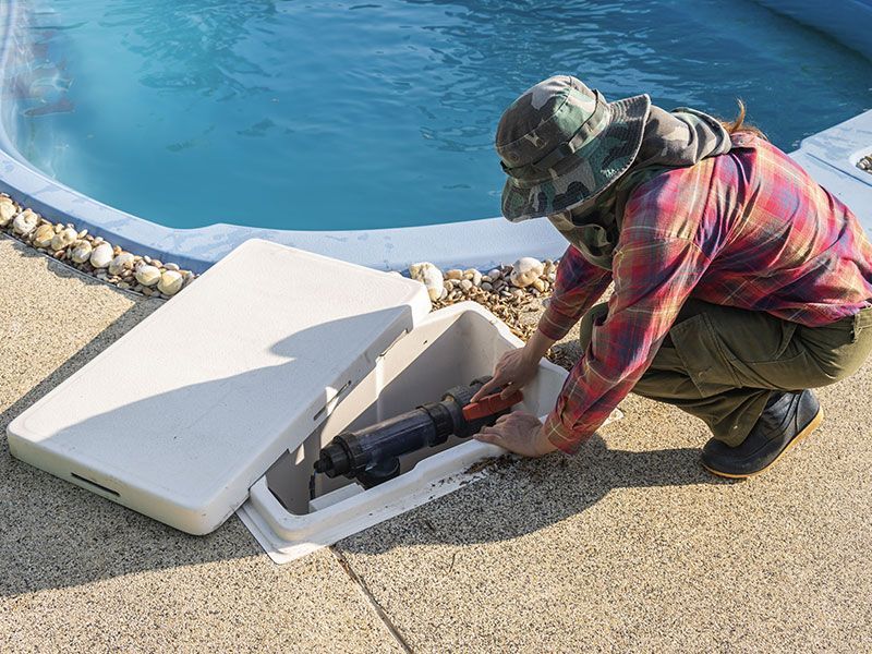 a man is working on a swimming pool .