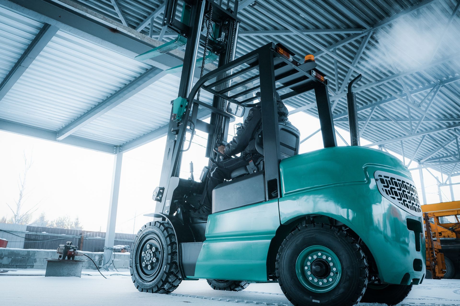 Orange ACE forklift outdoors on pavement.