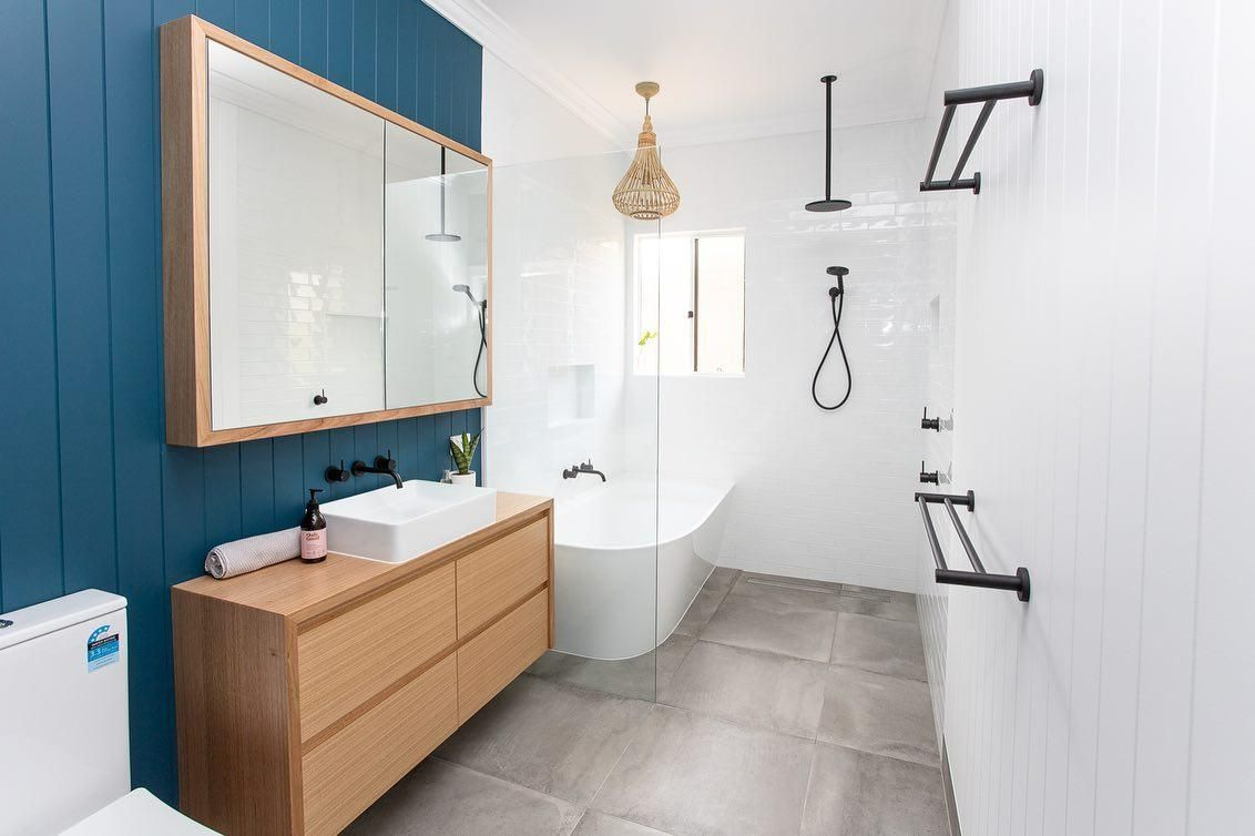 A Bathroom with A Sink, Toilet, Mirror and Bathtub — Caldera Kitchens and Bathrooms in Lismore, NSW