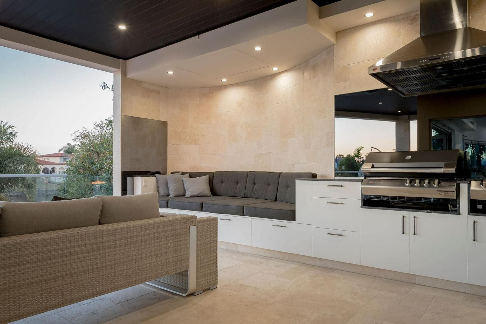 A Living Room with A Couch and A Kitchen with A Grill — Caldera Kitchens and Bathrooms in Lynchs Creek, NSW