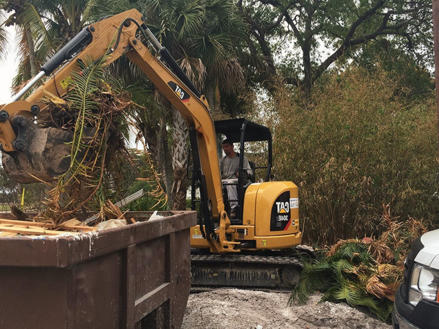 A mini excavator working at a small residential excavation site.