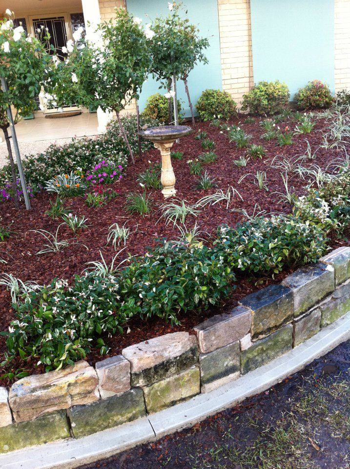 There is a bird bath in the middle of the garden.