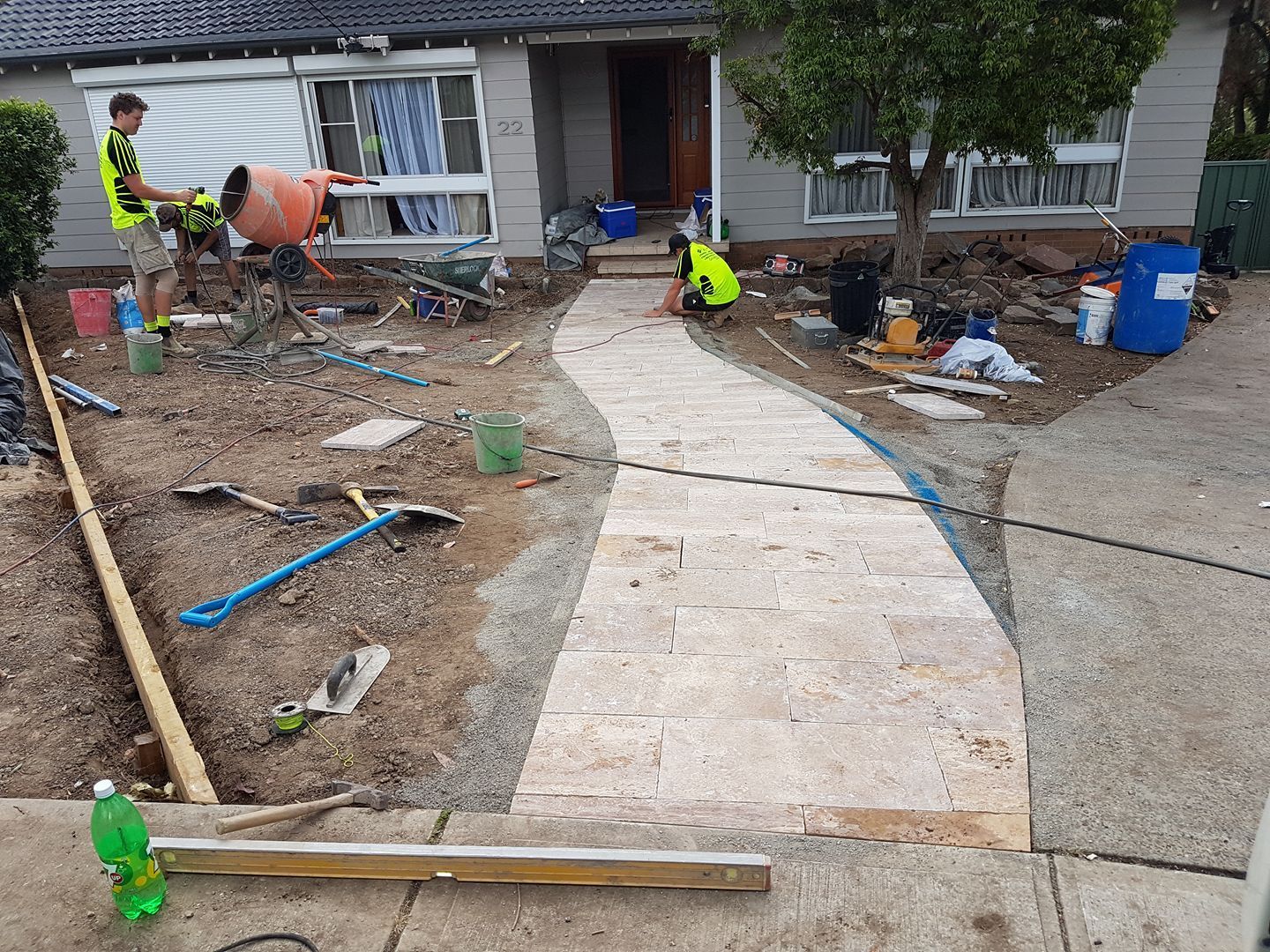 A concrete walkway is being built in front of a house.