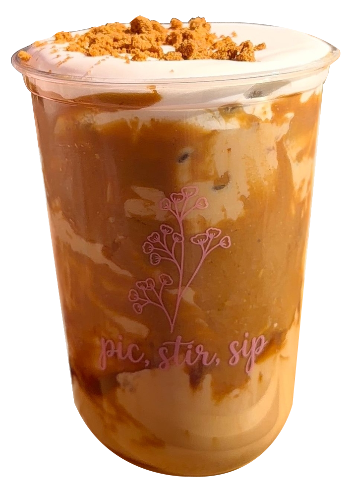 Iced coffee in a clear plastic cup with whipped cream and cinnamon topping