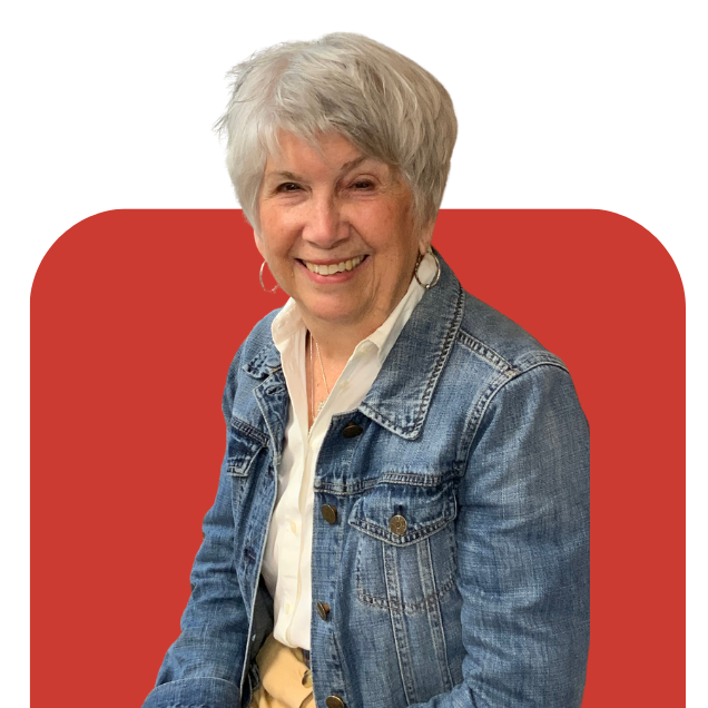 Smiling person in a denim jacket against a red background