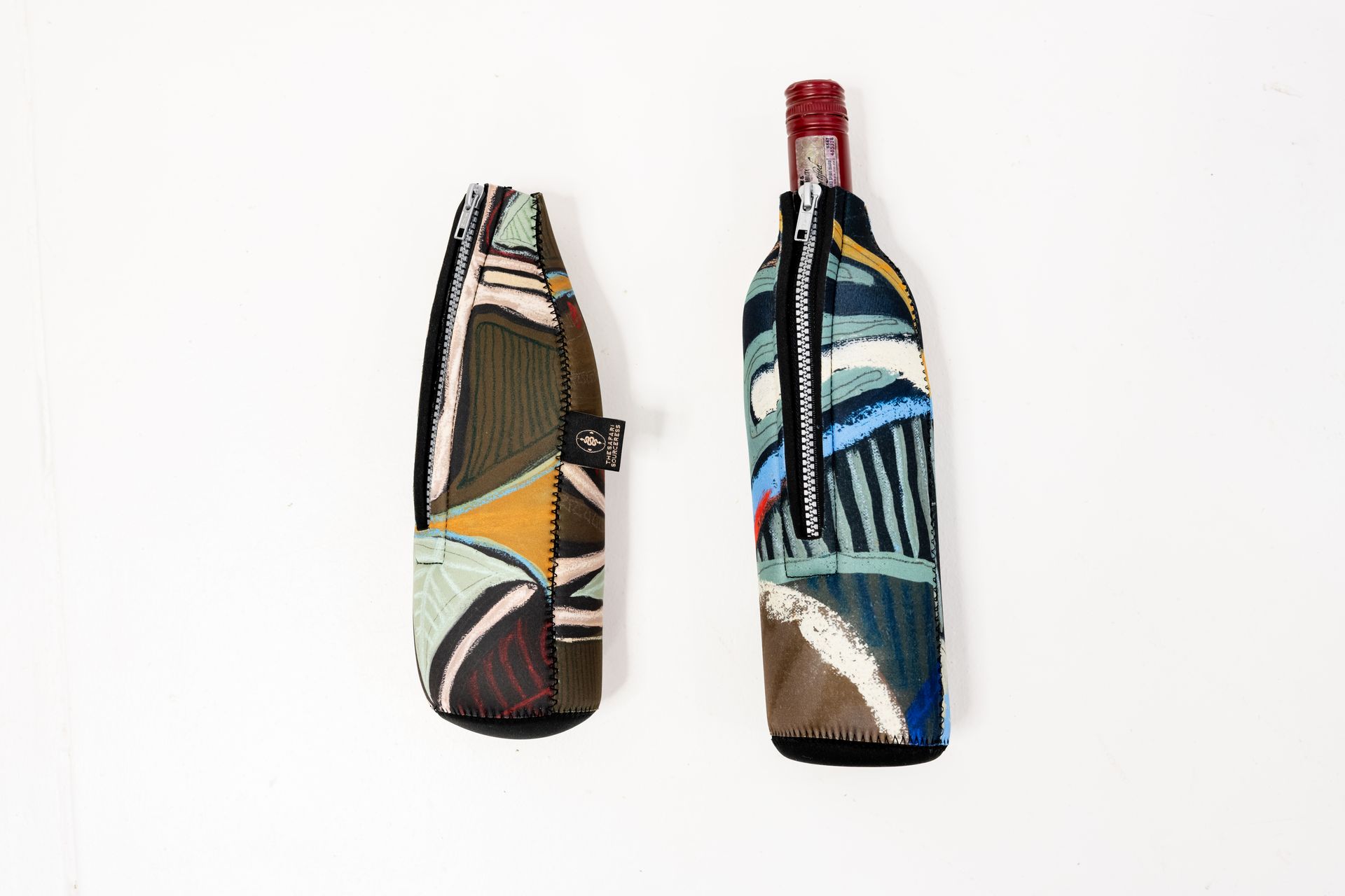 Two patterned, zippered insulated wine bottle sleeves on a plain white background, one holding a wine bottle.