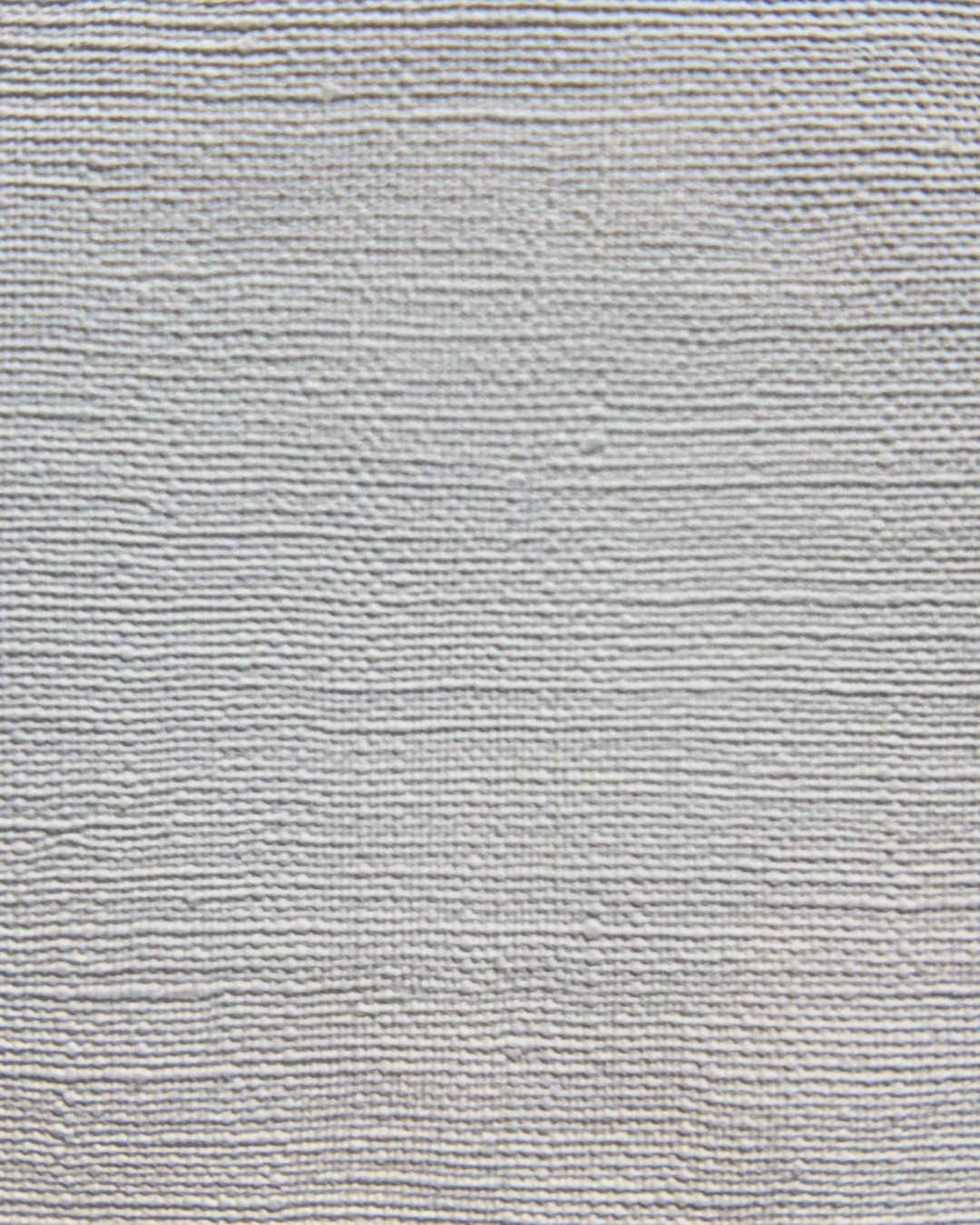 Close-up of a light gray textured fabric surface with horizontal woven lines