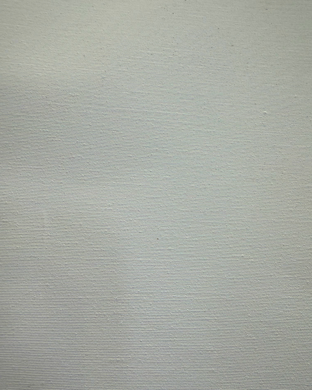 Close-up of light gray textured fabric with diagonal ribbed lines