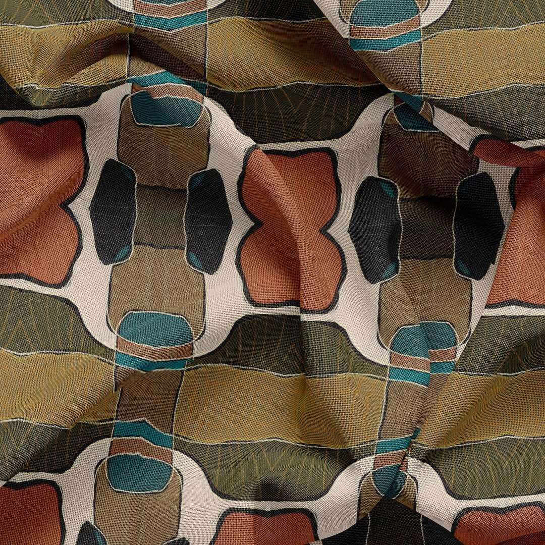 Close-up of a patterned quilt with tan, teal, rust, and black fabric patches