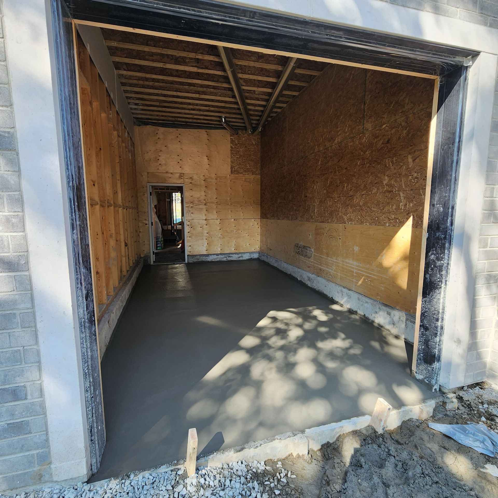 A concrete floor in a garage under construction