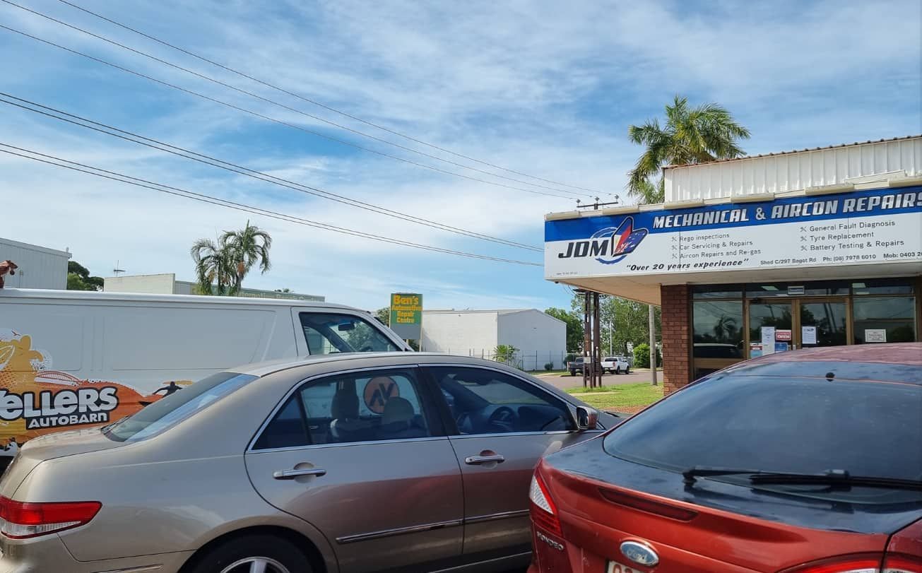 A Row of Cars Are Parked in Front of a Building — JDM Mechanical & Aircon Repairs In Coconut Grove, NT