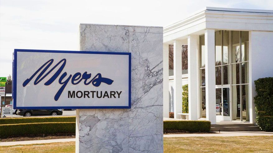 Myers Mortuary sign outside a white building with tall columns