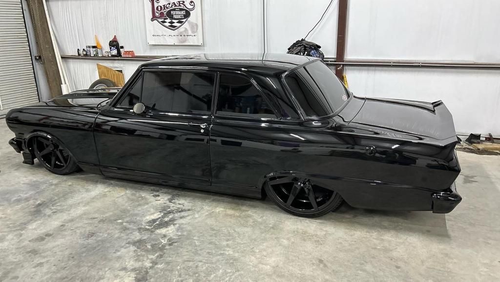 A black car is parked in a garage.