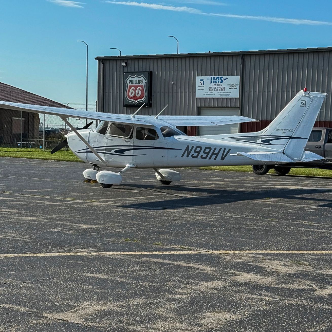 A small white airplane is sitting on a runway.