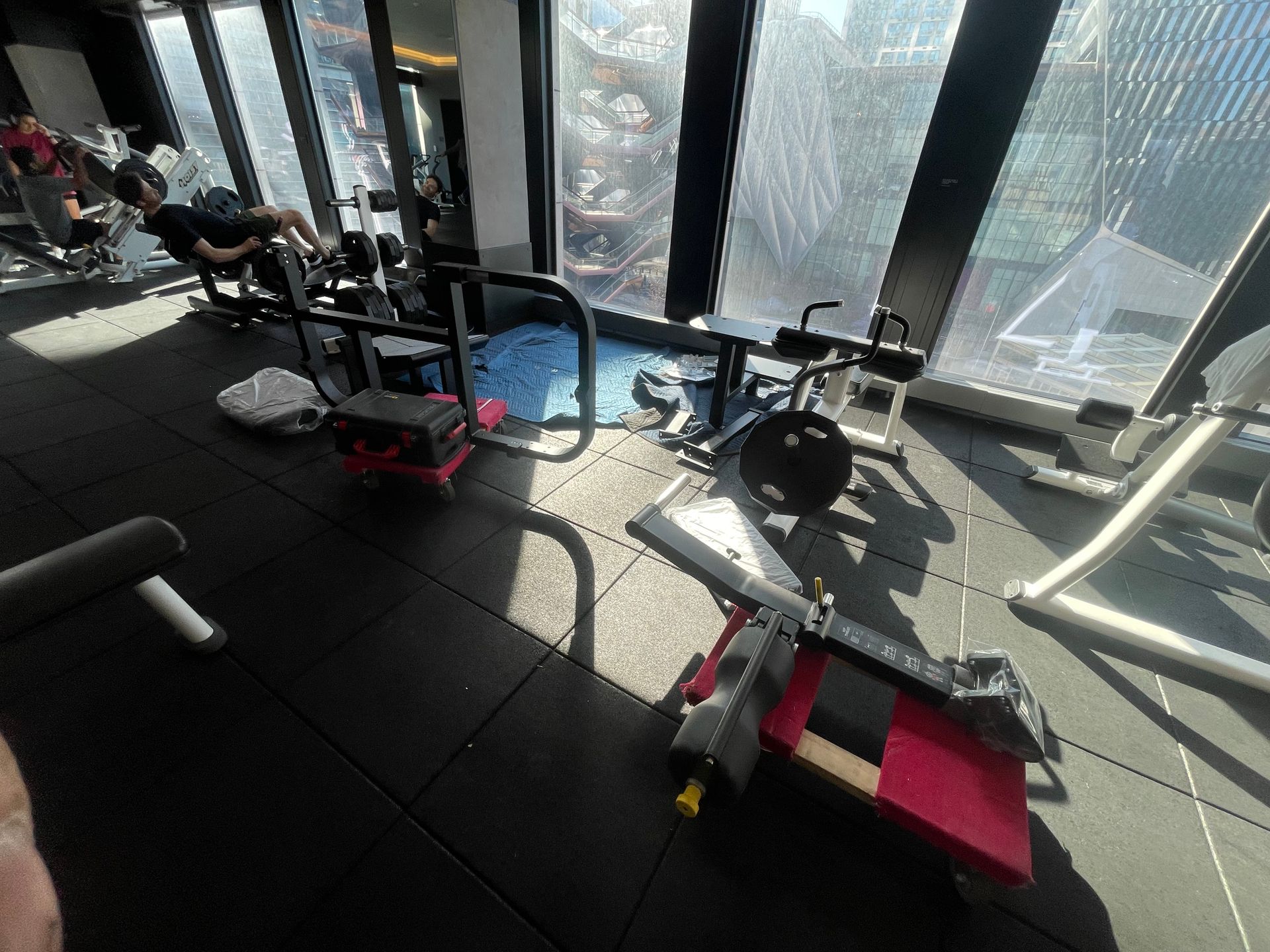 Multiple cardio and strength machines placed in commercial fitness center space.