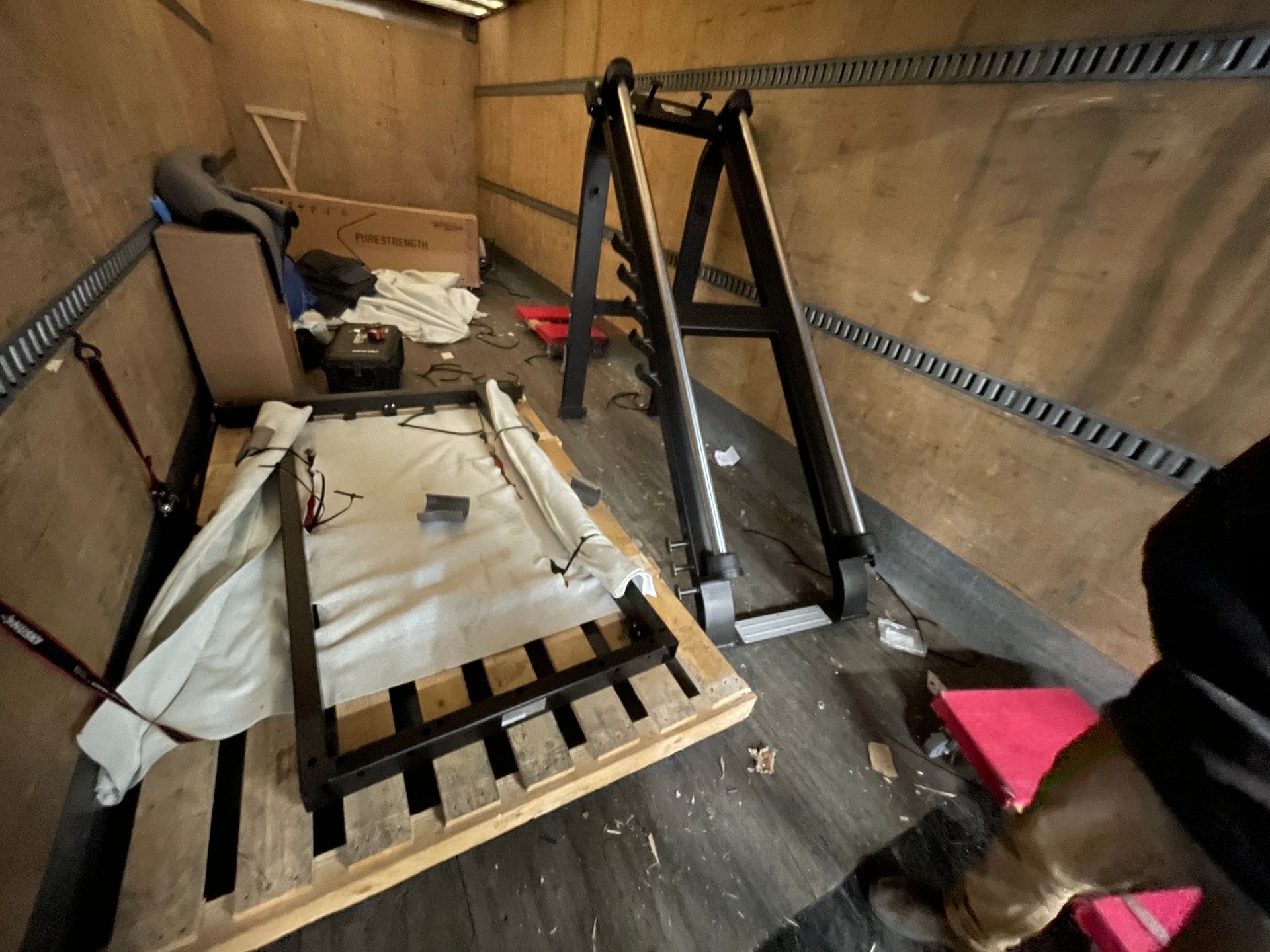 Gym equipment parts and packaging inside a truck during delivery.