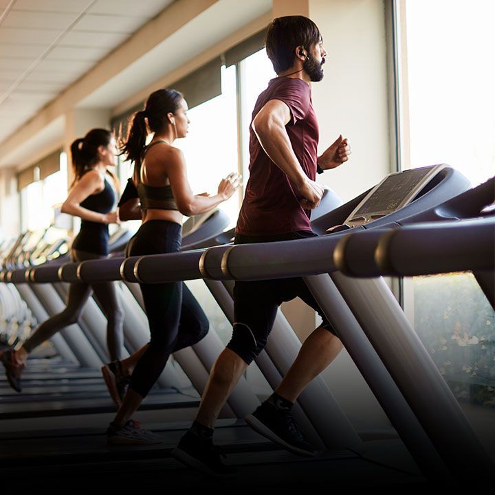People running on treadmills at a gym highlighting Service King treadmill services