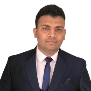 Man in a suit and tie, looking forward, with a neutral expression, against a white background.