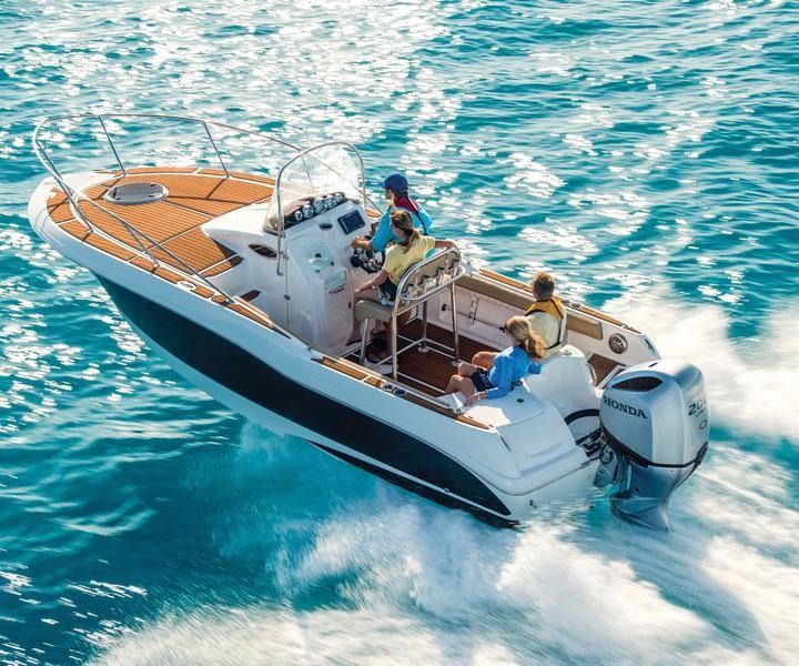 A Boat With People On It Is Floating On Top Of A Body Of Water — Cannonvale Marine In Jubilee Pocket, QLD