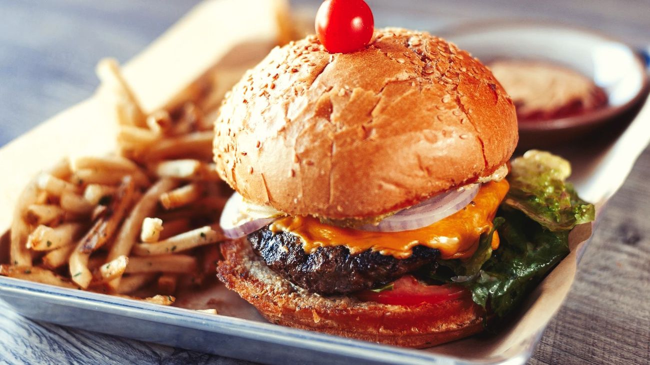 A cheeseburger with french fries
