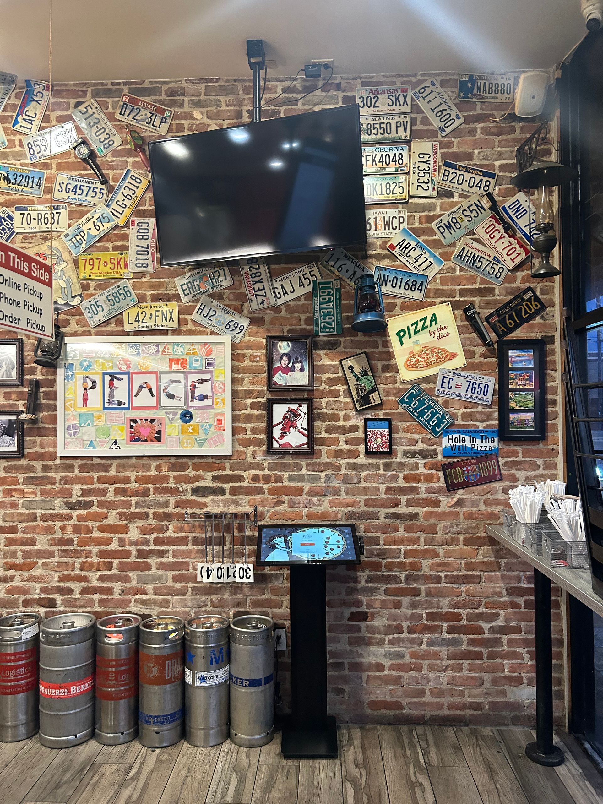 a room with a brick wall and a television on the wall .