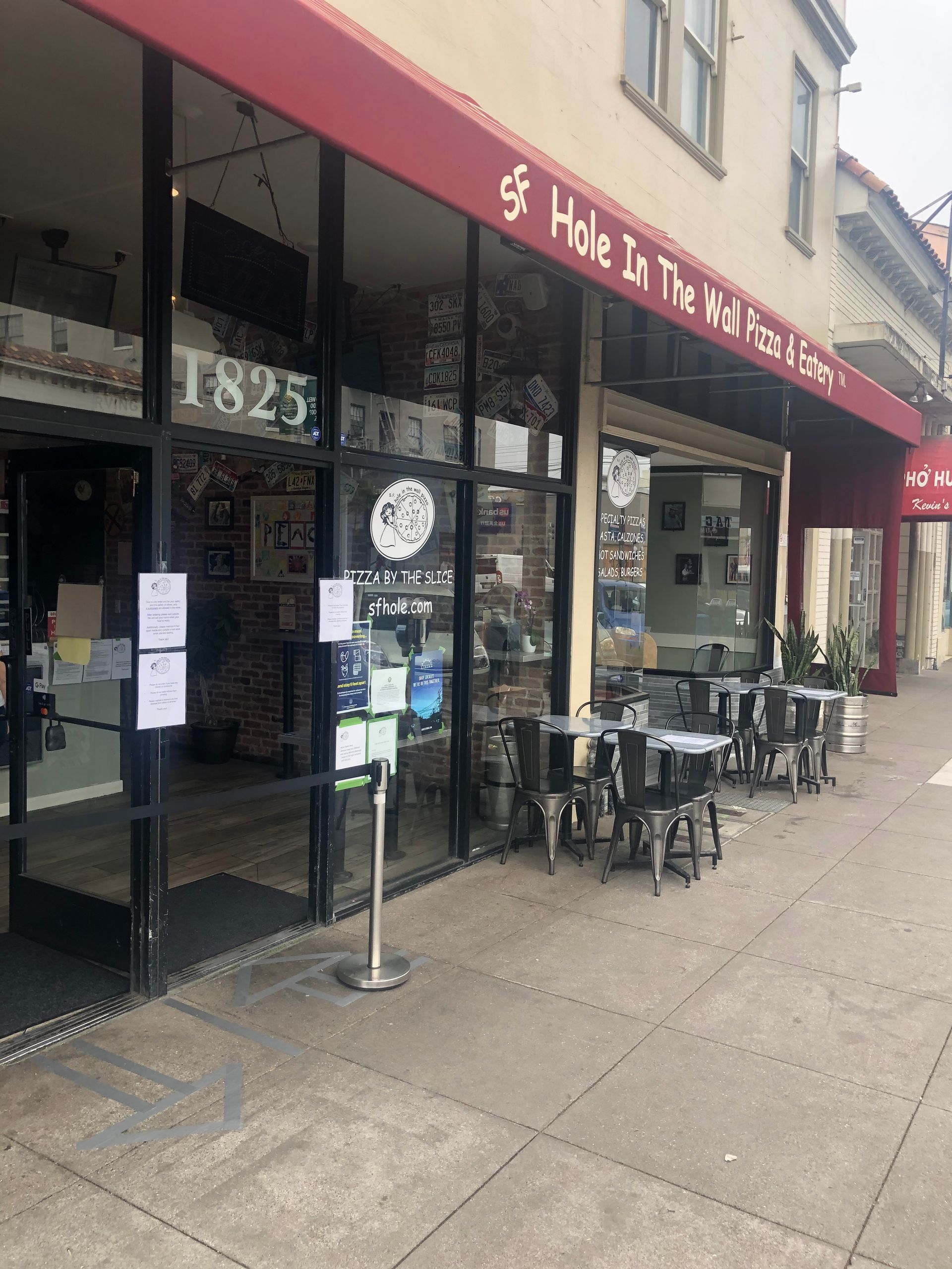 a restaurant with tables and chairs outside of it