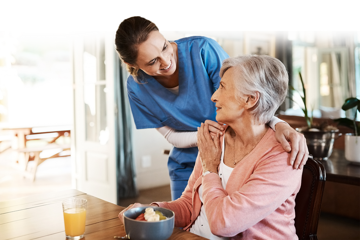 nurse reassuring elderly patient 