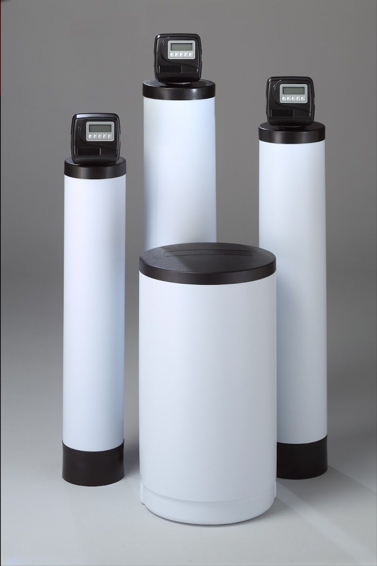 Three white cylinders with black lids are sitting next to each other on a table.