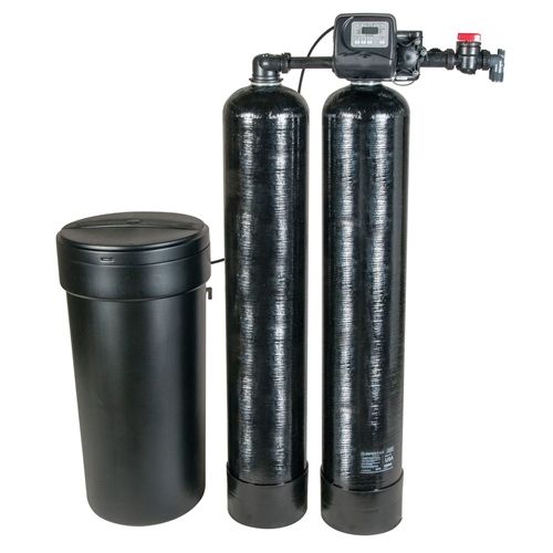 A water softener is sitting next to two black cylinders on a white background.