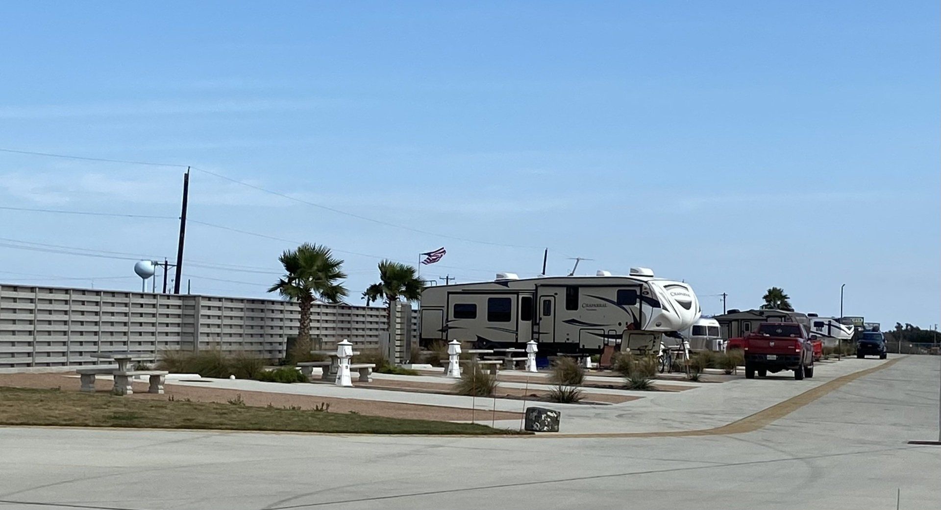 A row of rv 's are parked on the side of a road.