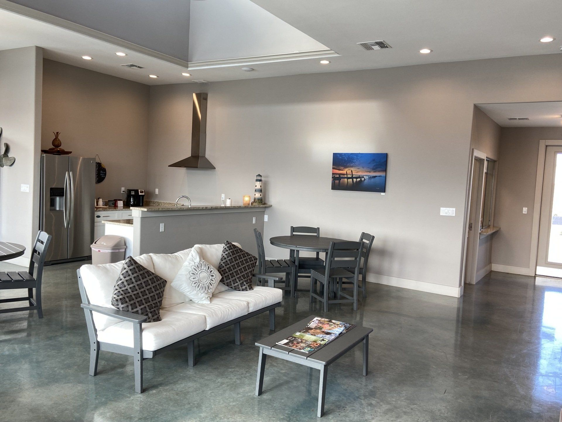 A living room with a couch a table and chairs