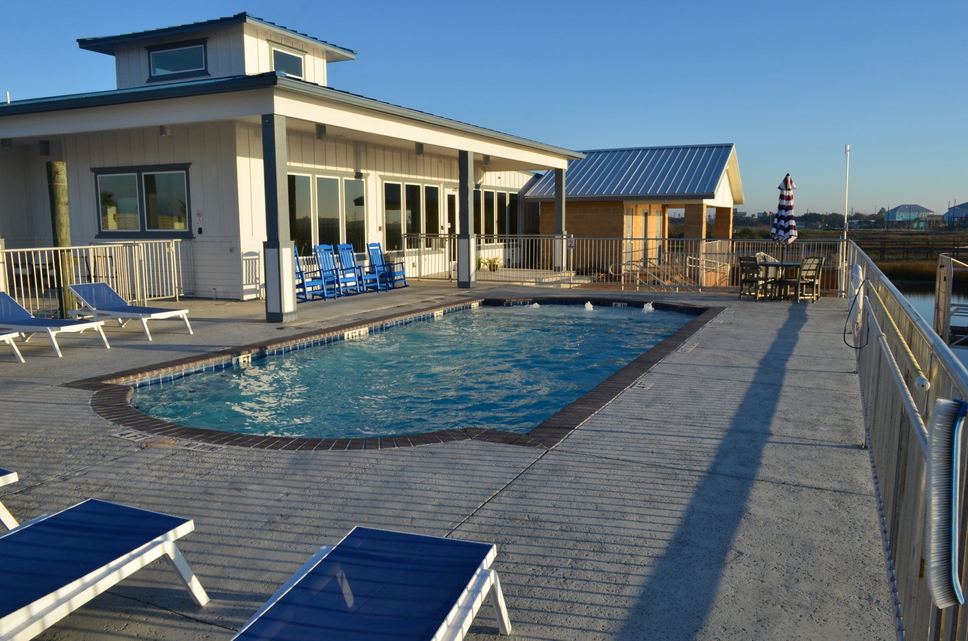A large swimming pool in front of a house