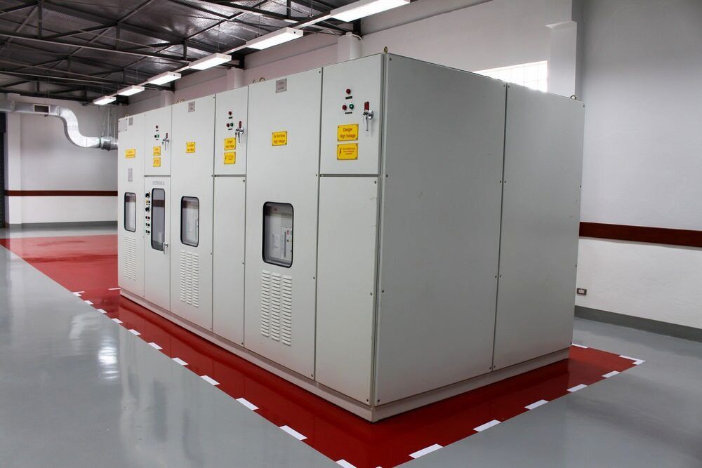 Large Gray Electrical Cabinet in a Room With a Red-bordered Floor — Darwin Electrical Services in Palmerston, NT