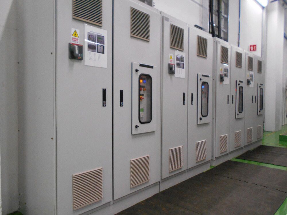 Row of Gray Electrical Cabinets With Vents, Windows, and Warning Labels — Darwin Electrical Services in Humpty Doo, NT