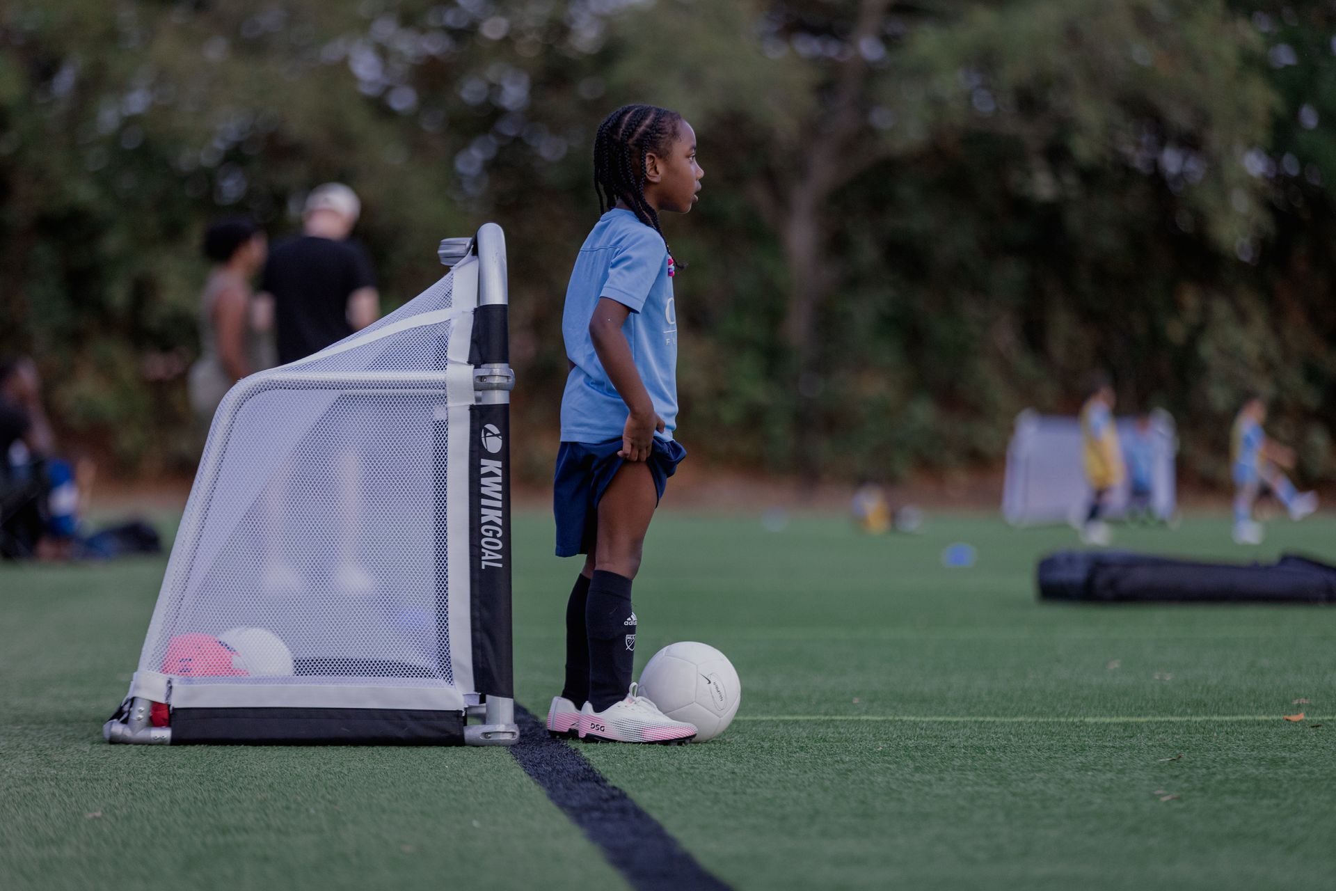 A First Touch player standing beside the goal with a ball
