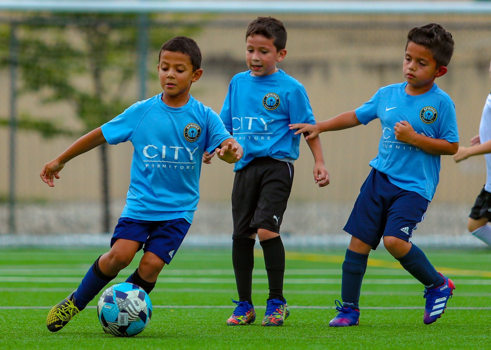 Three Springs Soccer Club players competing for the ball